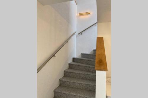a staircase in a house with grey stairs at Ferienwohnung zum Mandelgraben in Brauneberg