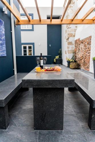 a table with a plate of food on top of it at Garden - Casa Sao Joao - 4 Star Tourist Apartments in Angra do Heroísmo