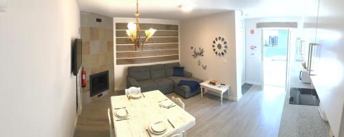 a living room with a couch and a table at Garden - Casa Sao Joao - 4 Star Tourist Apartments in Angra do Heroísmo