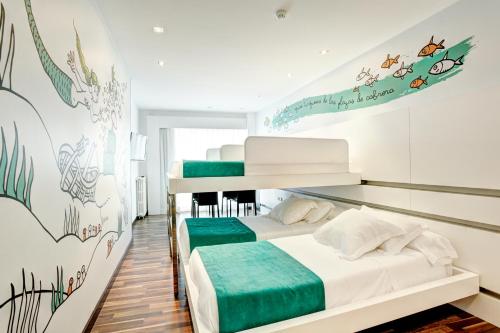 a bedroom with two bunk beds and a mural at Hotel Costa Azul in Palma de Mallorca