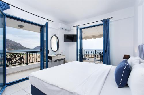 a bedroom with a bed and a balcony at Venti Seaside Adult Hotel in Monemvasia