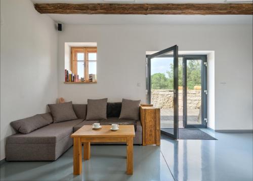 a living room with a couch and a table at Roubenka U Babi in Lipná