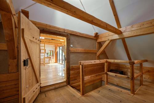 a room with wooden walls and a wooden door at Roubenka U Babi in Lipná
