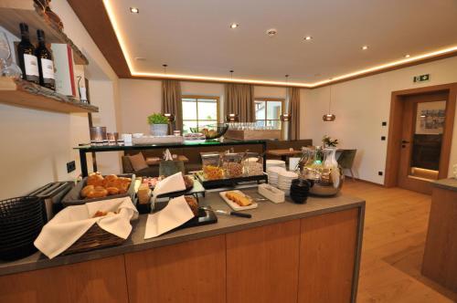 a breakfast bar with food on a counter in a room at Hotel-Garni "Das Seebichl" in Achenkirch