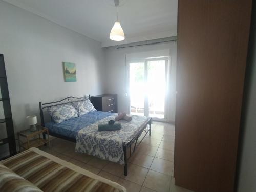 a bedroom with a bed and a window at Traveler Homes 2 in Kavála