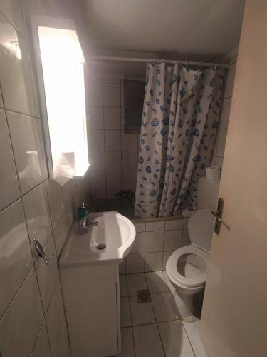 a small bathroom with a sink and a toilet at Traveler Homes 2 in Kavála