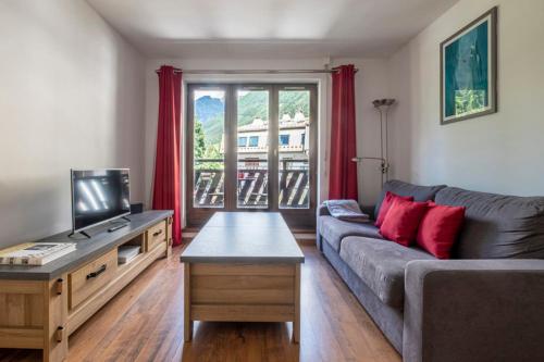 a living room with a couch and a tv at Modern Apt With Balcony In The Center Of Chamonix in Chamonix