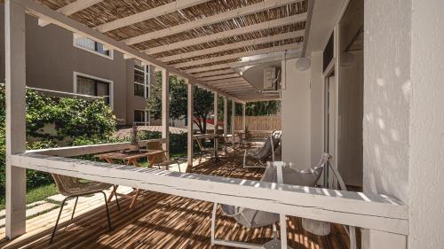 a patio with tables and chairs on a house at La Finca - Saint Vlas in Sveti Vlas