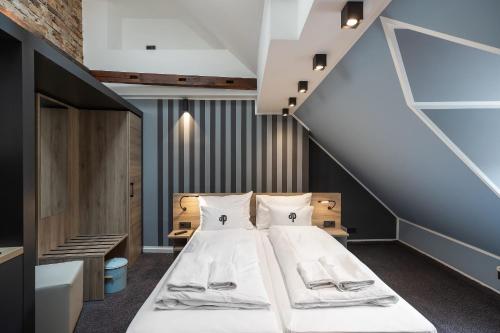 a bedroom with a bed and a staircase at Oldtown Studios by dasPaul in Nuremberg