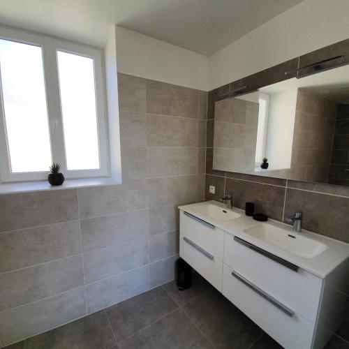 une salle de bain avec un lavabo blanc et un miroir dans l'établissement La Tour de l'Hirondelle, à Lussas