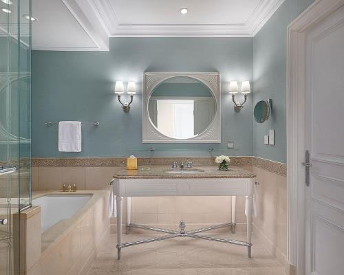 a bathroom with a sink and a mirror and a tub at Four Seasons Hotel Alexandria At San Stefano in Alexandria