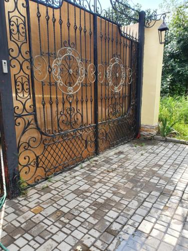 a black gate with a brick walkway in front at Смарт квартира сдана 2019 in Odesa