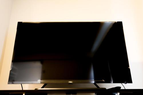 a flat screen tv sitting on top of a table at Fukuoka Condominium in Fukuoka