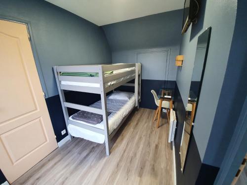 a small room with a bunk bed and a door at Hôtel-Restaurant Le Flobart in Le Portel