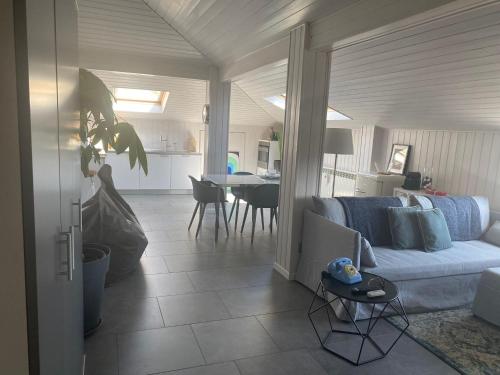 a living room with a white couch and a table at La Garçonniérre del Lago Maggiore in Nebbiuno
