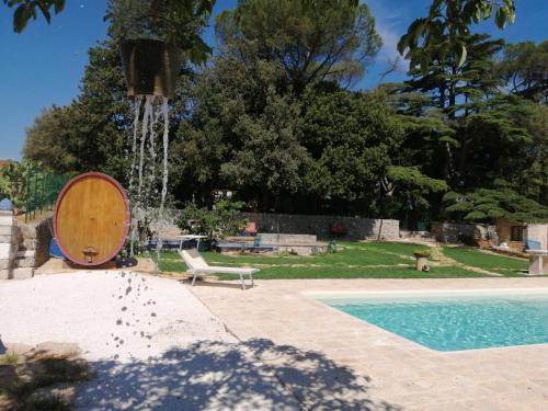 a swimming pool with a water fountain with a boat at Tenuta Colavecchio B&B in Putignano