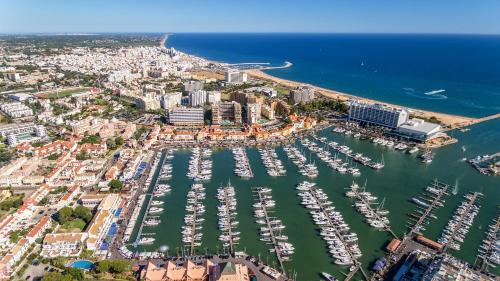 an aerial view of a harbor filled with boats at Hotel Atismar in Quarteira