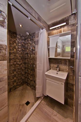 a bathroom with a sink and a shower at Guest house Stefan in Balchik