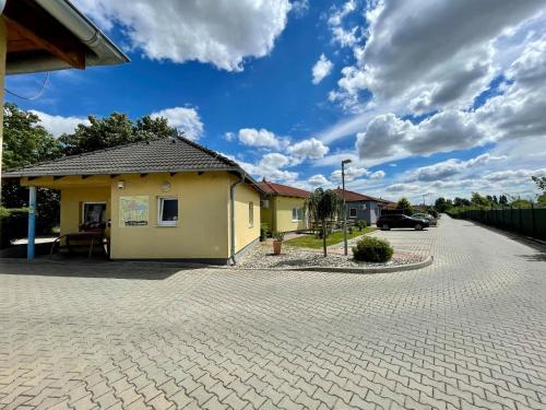 a house with a brick driveway at Holiday Village Senec in Senec