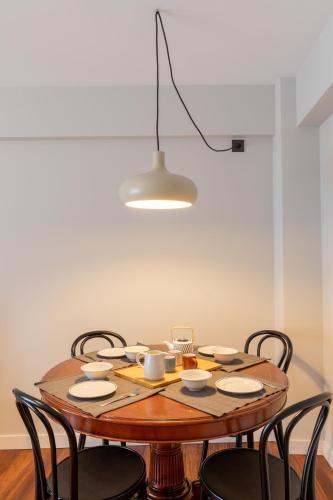 a dining room table with chairs and aendant light at Agirre - BasKey rentals in Lekeitio
