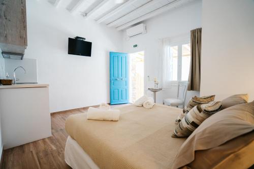 a bedroom with a large bed with a blue door at Grand View in Kamares