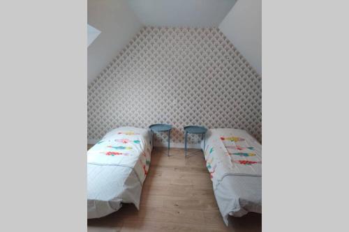Zimmer mit 2 Betten und 2 Stühlen in der Unterkunft Gite de Kerampif in Pluherlin