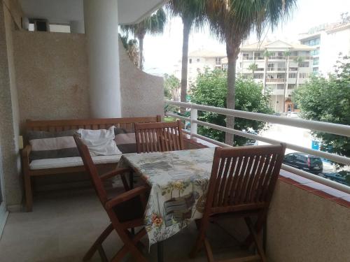 a balcony with a table and chairs on a balcony at Albir Sunshine Apartments in Albir