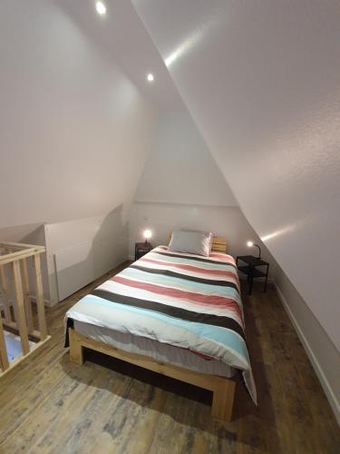 a bedroom with a large bed in a attic at Les Gites de Claire in Saint-Gâtien-des-Bois