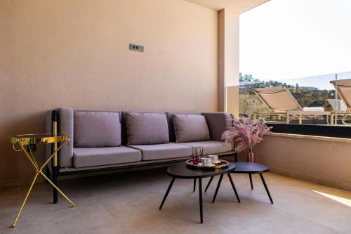 a living room with a purple couch and a table at Villa Nina - Apartments with pool near the sea in Rabac