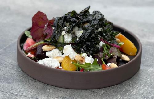 a salad in a brown bowl on a table at Villa Brunnby in Mölle
