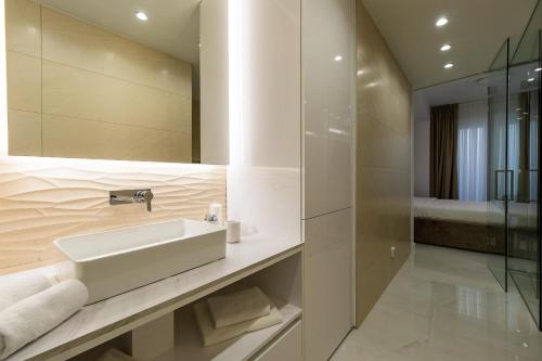 a bathroom with a sink and a mirror at Villa Nina - Apartments with pool near the sea in Rabac