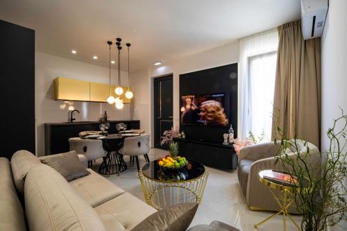 a living room with a couch and a dining room at Villa Nina - Apartments with pool near the sea in Rabac
