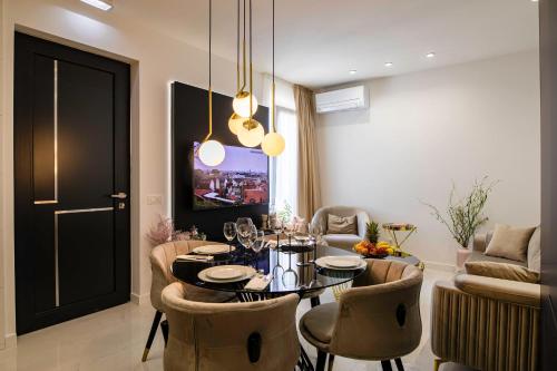 a living room with a dining table and chairs at Villa Nina - Apartments with pool near the sea in Rabac