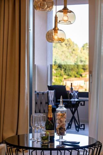 a table with glasses and a bottle of wine at Villa Nina - Apartments with pool near the sea in Rabac