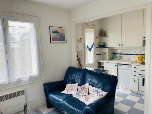 un salon avec un canapé en cuir bleu dans une cuisine dans l'établissement CONCORDE - St Colomban, Jardin, Vue mer - T7, à Carnac
