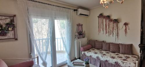 a room with a window and a bed and a window at Iris Deluxe Suites 1 in Kavála