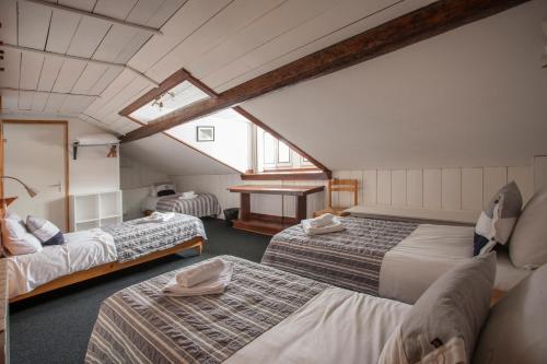 A bed or beds in a room at La Chaumière Mountain Lodge