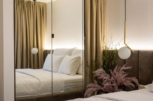 a mirror in a bedroom with a bed at Villa Nina - Apartments with pool near the sea in Rabac