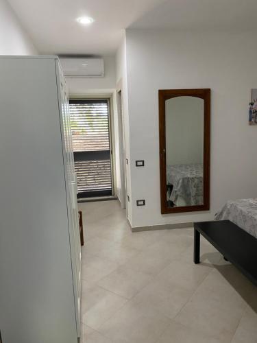 a living room with a mirror and a bed at La casa del Maestro in Pisciotta