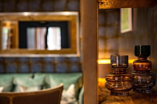 two glass bottles sitting on a table in a library at No33 HUNSTANTON BOUTIQUE ROOMS in Hunstanton
