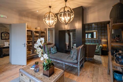 a living room with a couch and chandeliers at No33 HUNSTANTON BOUTIQUE ROOMS in Hunstanton