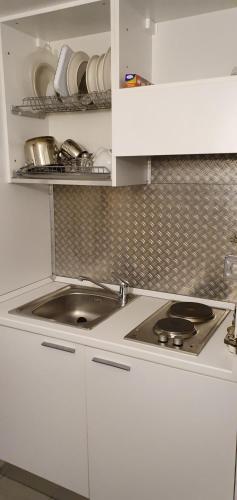 a kitchen with a sink and a counter top at La casa di Balto, un nido per 2 in Castelnuovo Magra