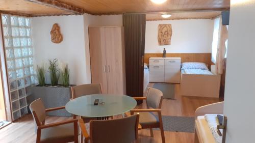 a room with a table and chairs and a kitchen at Penzion u Šmídů Náměstí in Jaroslavice