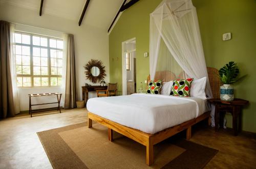 a bedroom with a bed with a canopy at The Safari House in Usa River
