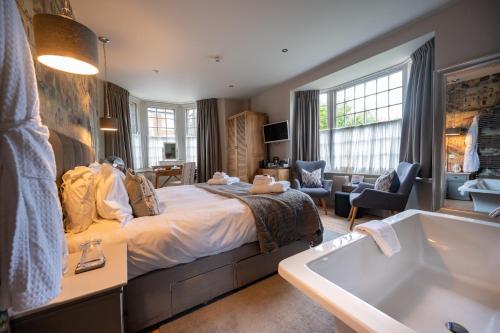 a bedroom with a bed and a bath tub at No33 HUNSTANTON BOUTIQUE ROOMS in Hunstanton