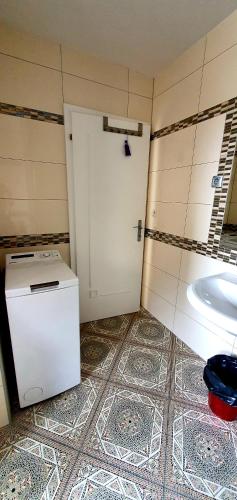 a bathroom with a white door and a sink at Apartment Luna in Ptuj
