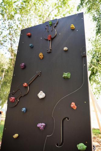 a climbing wall with a clock on it at JURA GLAMP luksusowe całoroczne domki na wyłączność KOPUŁY IGLOO taras ogród in Wola Kalinowska