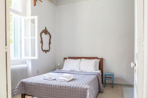 a bedroom with a bed with two towels on it at Athenian Yard Near Acropolis in Athens