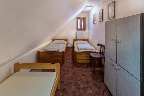 a room with three bunk beds and a staircase at Penzion U Ráztoky in Rusava