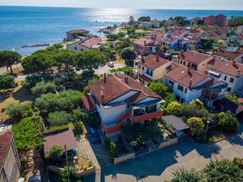 an aerial view of a residential neighborhood next to the ocean at Apartments Grahovac in Umag